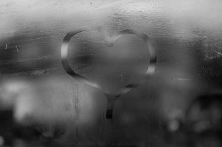 Heart on a wet windowの写真素材