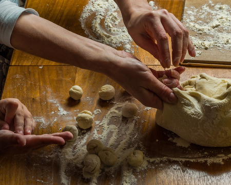 Mom and daughter are making flour out of flour to cook dumplingsの写真素材