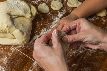 Mom and daughter are making flour out of flour to cook dumplingsの写真素材