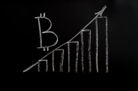 Bitcoin inscription with white chalk on a black boardの写真素材