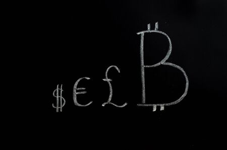 Bitcoin inscription with white chalk on a black boardの写真素材
