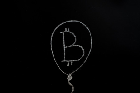 Bitcoin inscription with white chalk on a black boardの写真素材
