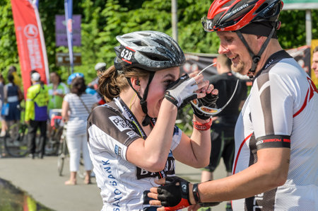 LVIV, UKRAINE - MAY 2018: Emotional greeting at the finish of a cyclist's athlete and rewarding him with a medalのeditorial素材