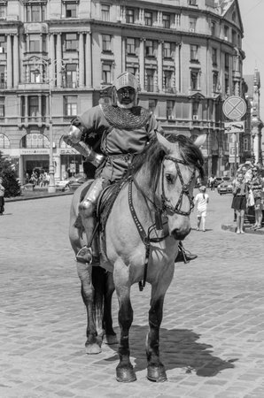 LVIV, UKRAINE - MAY 2018: Knight sitting on a horse in a carnival costume rides in the center of the city on paradeのeditorial素材
