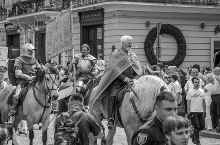 LVIV, UKRAINE - MAY 2018: Knight sitting on a horse in a carnival costume rides in the center of the city on paradeのeditorial素材