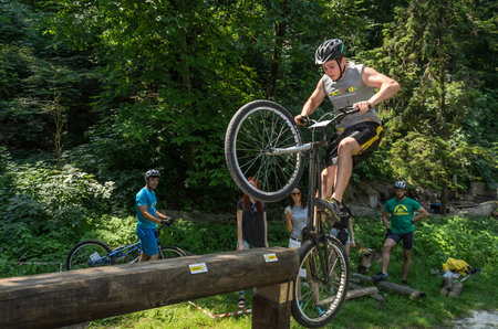 LVIV, UKRAINE - JUNE 2018: A cyclist performs tricks on a bicycle trial to overcome an obstacle courseのeditorial素材