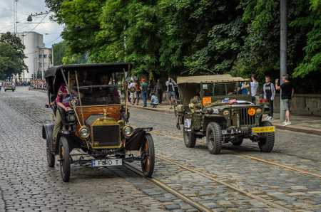 LVIV, UKRAINE - JUNE 2018: Old vintage retro car Ford T and army jeep Willys drive through the streets of the cityのeditorial素材
