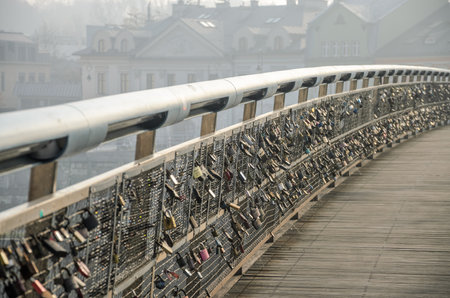POLAND, KRAKOW - NOVEMBER 2018: Locks of lovers hanging on the railing of the bridge Passerelle Pre Ojca Bernatkaのeditorial素材