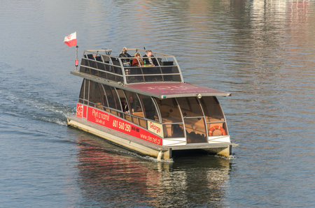 POLAND, KRAKOW - NOVEMBER 2018: Tourists ride on the Wisla River in Krakowのeditorial素材