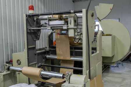 LVIV, UKRAINE - NOVEMBER 2018: Large paper bag making machine at factory