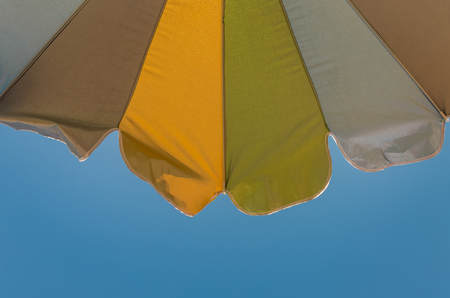 Multicolored sun umbrella on the sea beachの写真素材