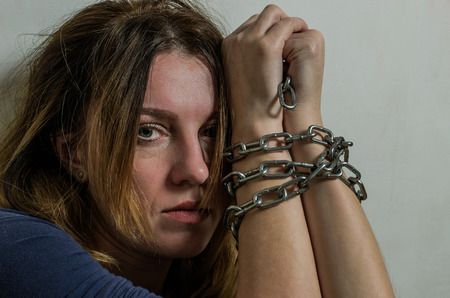 Young girl with chained hands