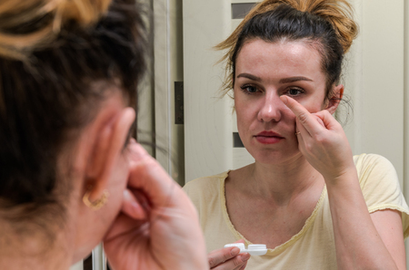 Woman wearing contact lenses for vision correctionの写真素材