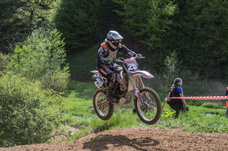 LVIV, UKRAINE - MAY, 2019: Athlete motorcycle race tracker and jumps on motorcycle trackのeditorial素材