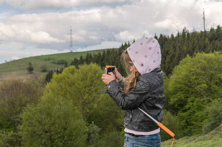 Little girl takes pictures while travelingの写真素材