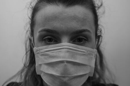 Young girl in a medical maskの写真素材