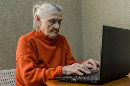 Elderly woman grandmother at a laptopの写真素材