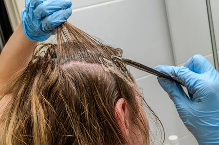 Master hairdresser dyes her hair herselfの写真素材