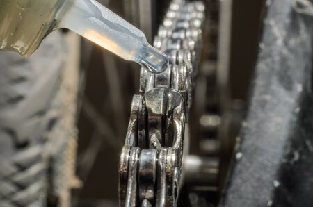 Master lubricates bicycle chainの写真素材