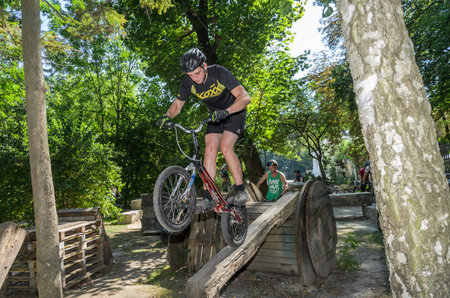 LVIV, UKRAINE - AUGUST 2020: The athlete is engaged in a sports bicycle trial overcoming obstacles on his bikeのeditorial素材