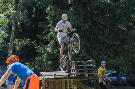 LVIV, UKRAINE - AUGUST 2020: The athlete is engaged in a sports bike trial overcoming obstacles on his bikeのeditorial素材