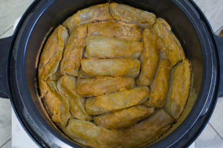 Cabbage rolls with meat are cooked in a saucepan