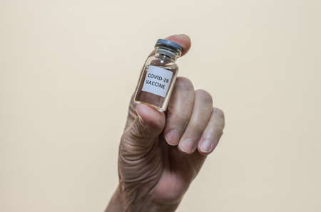 Covid-19 vaccine in the hand of an elderly woman