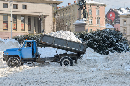 LVIV, UKRAINE - 09 FEBRUARY 2021: Snow removal truck unloads snowのeditorial素材
