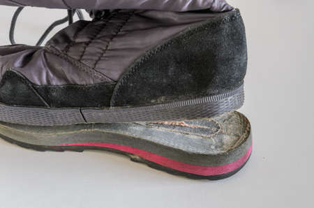 A shoemaker repairs a shoe, showing how the sole of a shoe came offの写真素材