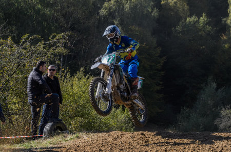 LVIV, UKRAINE - OCTOBER 2021: Athletes motorcycle racers compete in motocross competition on the race trackのeditorial素材
