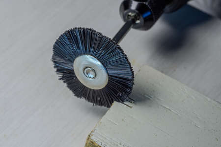 The master cuts a wooden plank with an engraverの写真素材