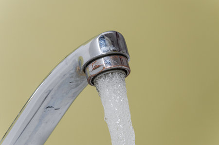 Water flows through the faucet aeratorの写真素材