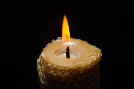 Burning flame candle isolated on black backgroundの写真素材
