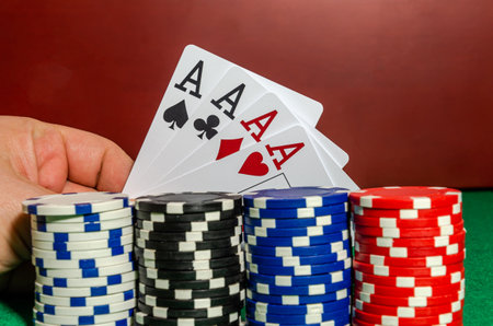 Four ace cards on the background of poker chips in a casino
