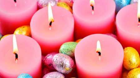 Colorful easter eggs and candles as a symbol of easterの素材