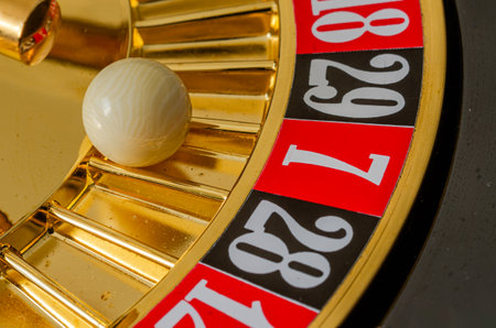 Casino roulette wheel with ball and numbers close-up.の素材