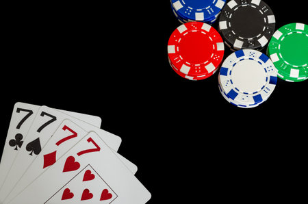 Poker chips and cards on a black background, close-up