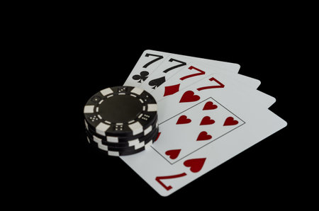 Playing cards and chips on a black background. The concept of gambling