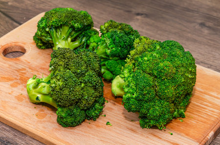 broccoli on a cutting board on a wooden background, close-upの写真素材