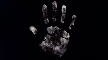 Handprint of a zombie on black background, halloween conceptの素材