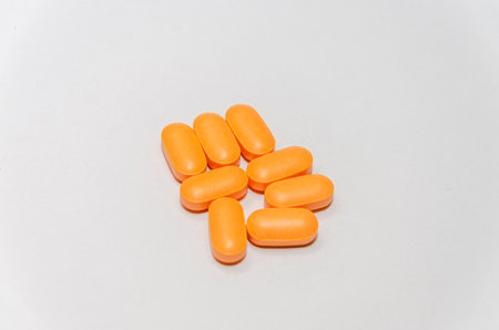 Orange pills isolated on white background with copy space for your text.の写真素材
