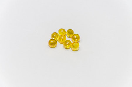 Cod liver oil omega 3 gel capsules isolated on a white background.の写真素材