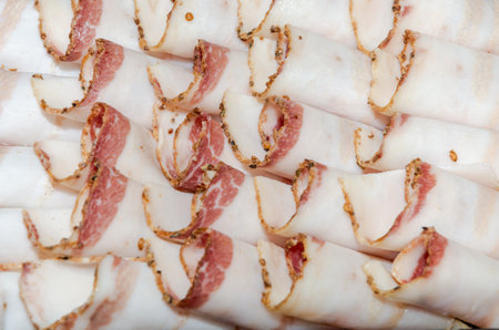 Slices of bacon on a white background, close-upの写真素材