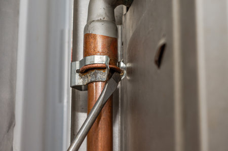 Close-up of a copper pipe for heating system in a boiler roomの写真素材