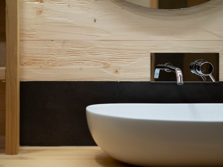 particular oval sink and faucet on wooden bathroom cabinetの写真素材