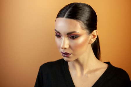 fashion portrait of an Asian type girl with burgundy eye shadows