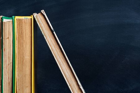 Old books on the chlakboard background. Learning concept. Copy spaceの写真素材
