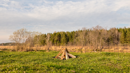 A bonfire in the field near the riverの写真素材