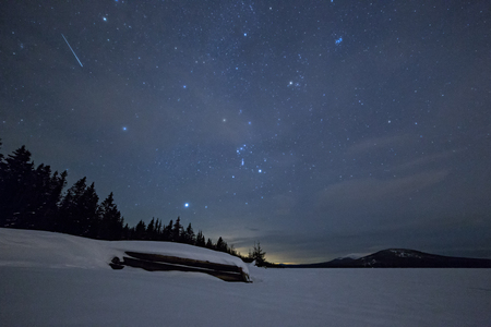 Inverted boat in winter against a starry skyの写真素材