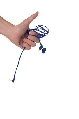 Hand holding blue tangled earphones and showing thumb up isolatedの写真素材
